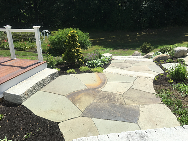 Harmonizing wood stone and plants in landscape design for a client of Stone Blossom Landscaping