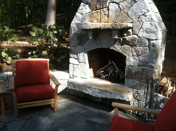 Outdoor fireplace and patio by Stone Blossom