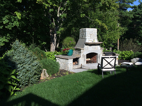 Outdoor fireplace designed and installed by Stone Blossom landscape and design