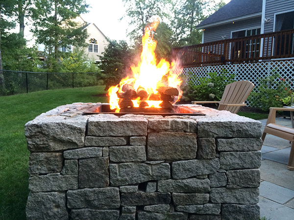 Wood burning fire pit for a landscape in Manchester New Hampshire by Stone Blossom