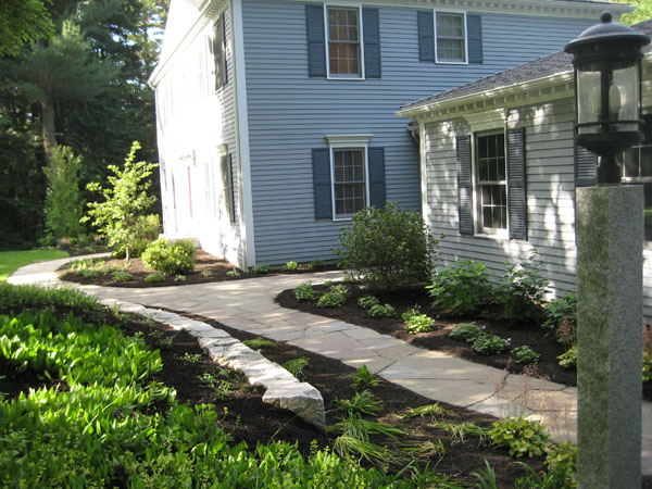 Classic stone walkway and plantings by Bedford landscape designer Stone Blossom