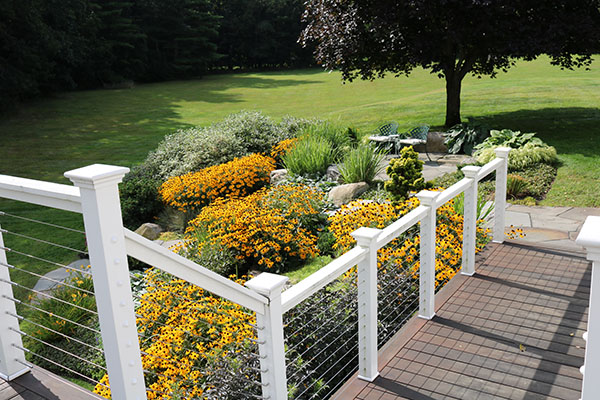 Deck leading to a beautiful patio and garden