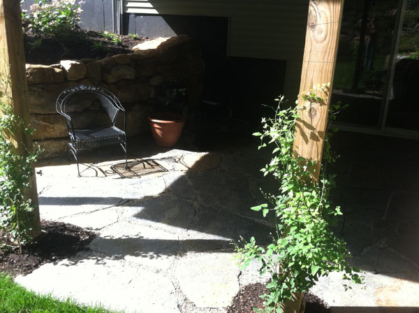 Shady patio under a deck in Hopkinton NH by landscaper Stone Blossom