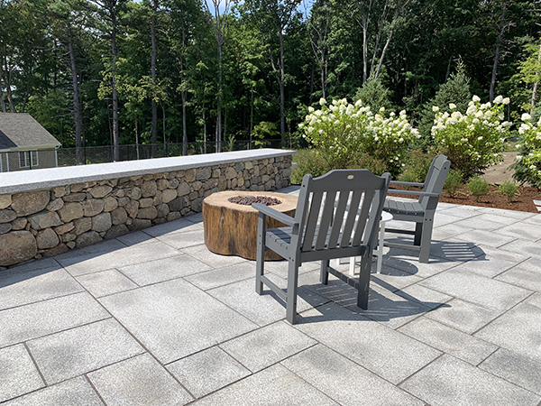 Granite patio and fieldstone seat wall